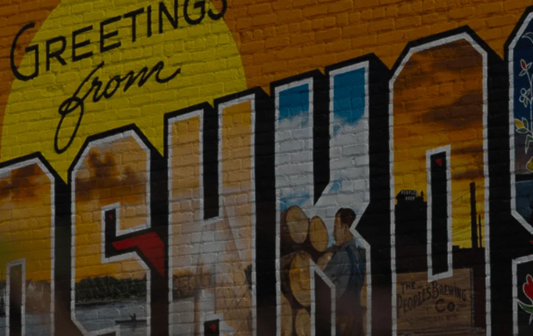 Colorful mural reading "Greetings from Oshkosh," featuring local imagery and vibrant designs against a sunny backdrop.